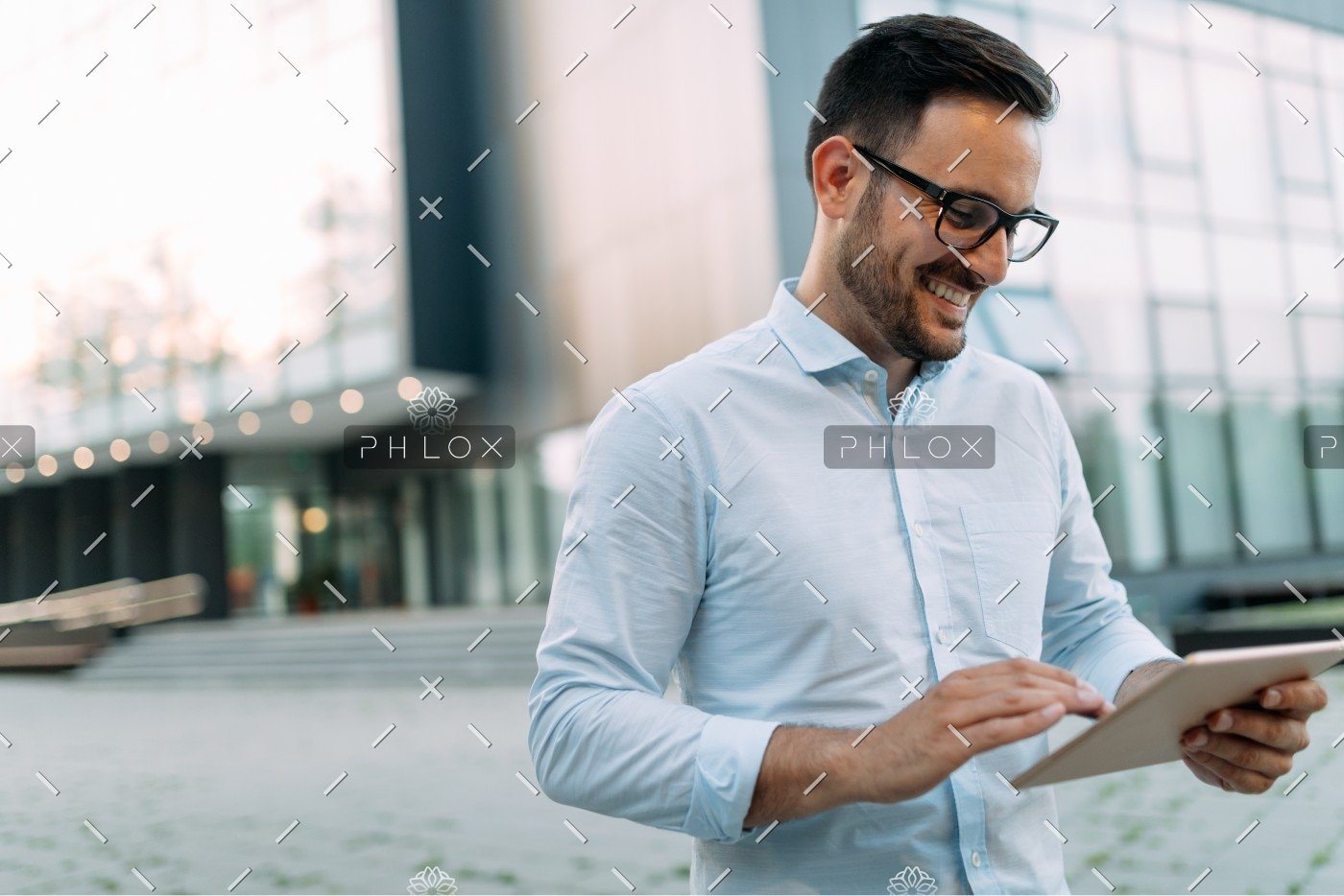 demo-attachment-2721-portrait-of-businessman-in-glasses-holding-tablet-AWVHCJU